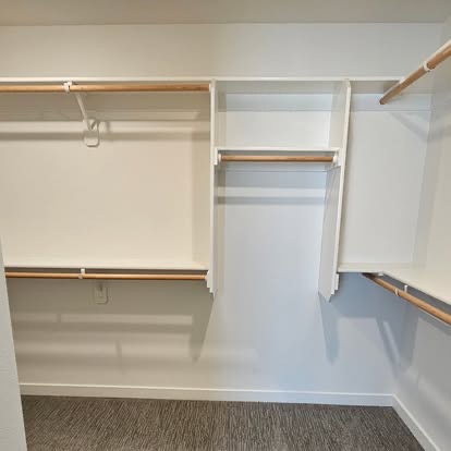 Empty walk-in closet with shelving
